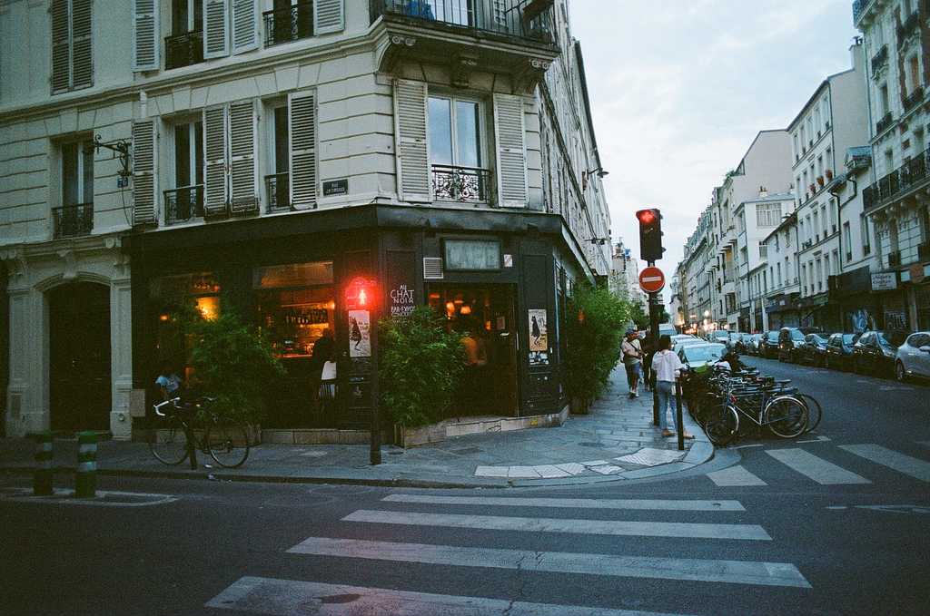 A photo of a street corner bar, Au Chat Noir, taken from across the street